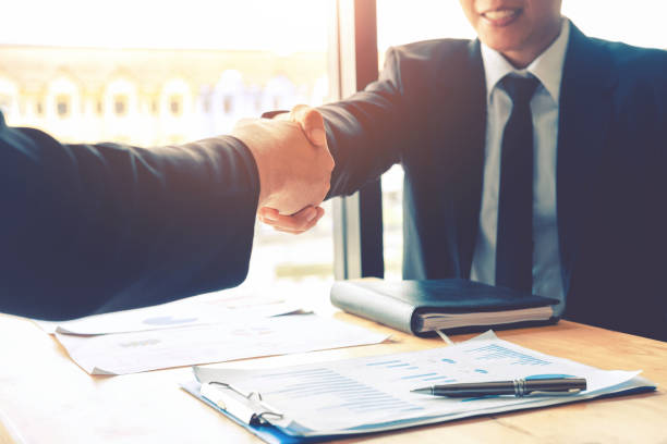 istock Business people colleagues shaking hands meeting Planning Strategy Analysis Concept 989117584