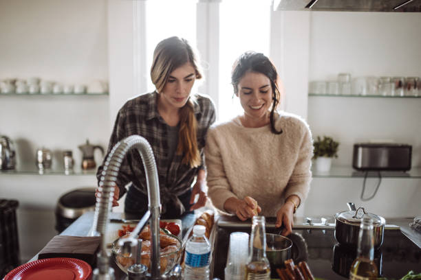 istock friends cooking together at home 989119500
