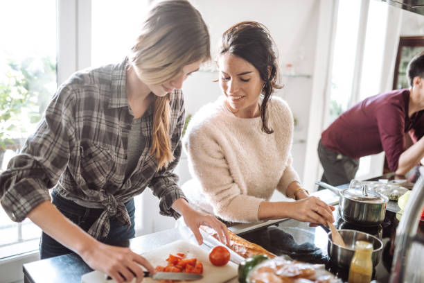 istock friends cooking together at home 989119836