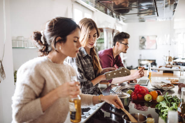 istock friends cooking together at home 989119966