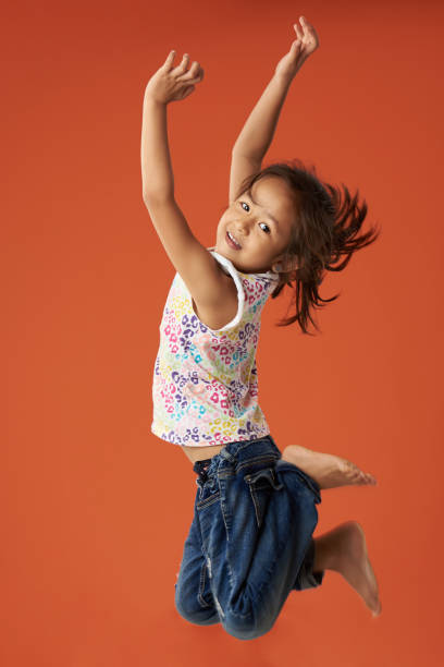 istock Small asian girl jump 989121650