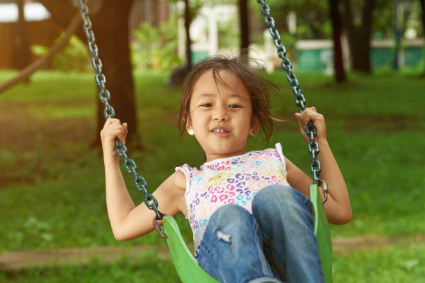 istock Asian girl playing on playground 989124176