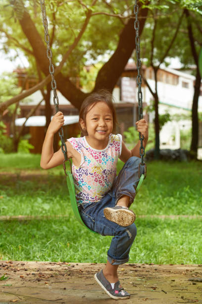 istock Asian girl sit on swings 989124398