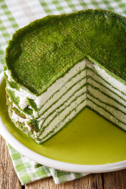 istock Snack spinach pancakes cake with cheese cream close-up. Vertical 989134248