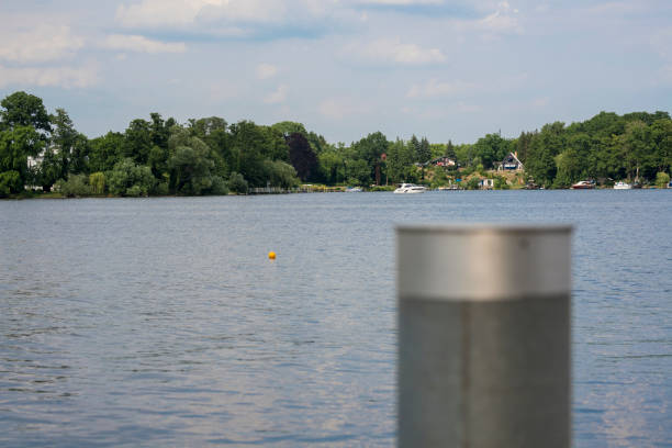 Glindower lake with bollard The Glindower lake in Germany on a sunny day with a bollard in the foreground bollard pier water lake stock pictures, royalty-free photos & images