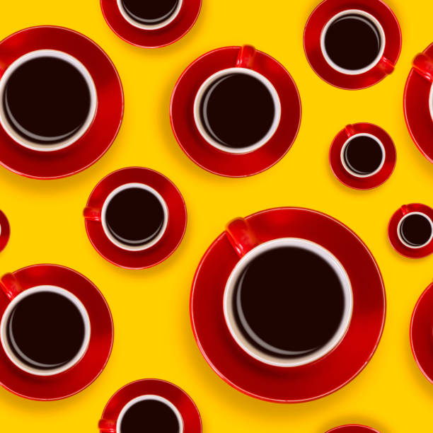 istock Seamless pattern with red coffee cups and a saucer on a yellow background 989199436