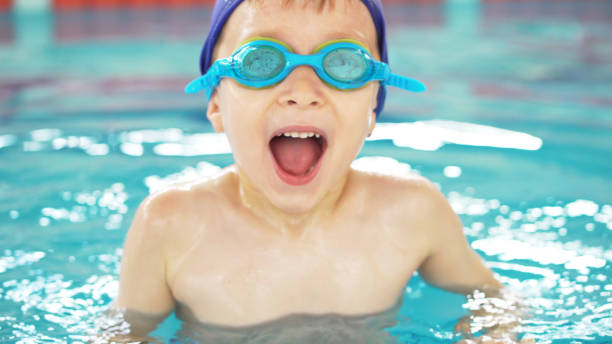 istock Boy in the swimming pool 989203088