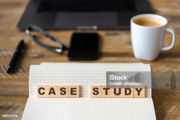 Closeup On Notebook Over Wood Table Background Focus On Wooden Blocks With Letters Making Case Study Text Stock Photo - Download Image Now