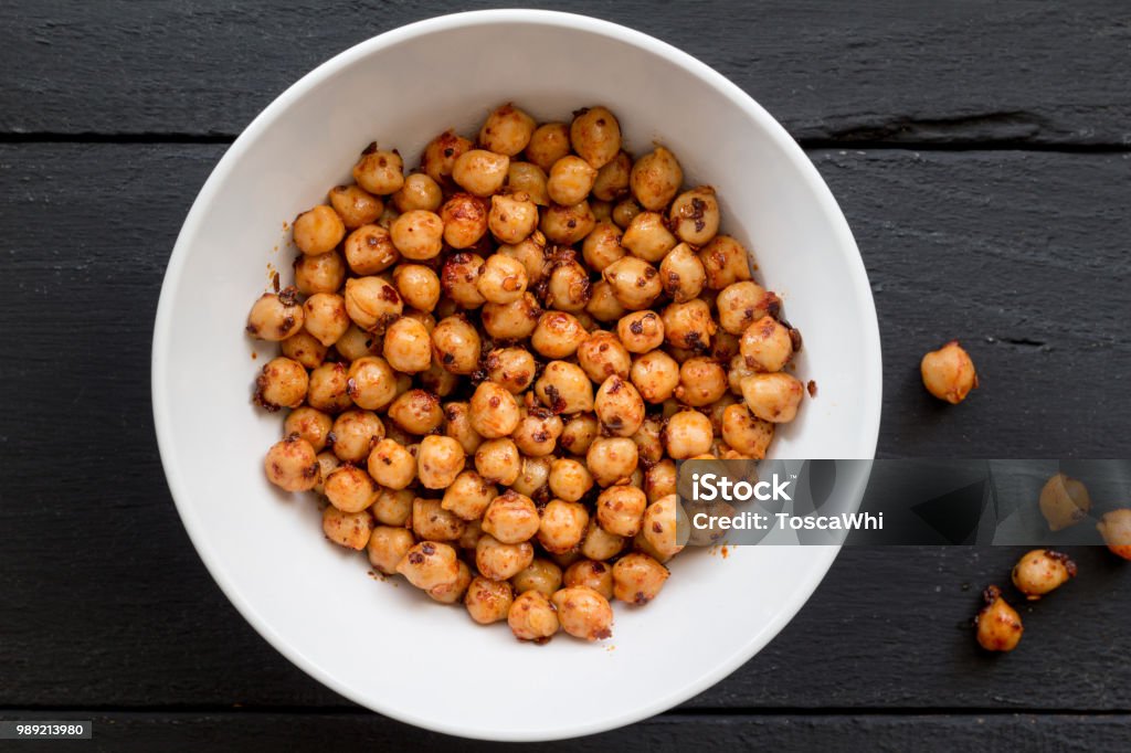 Chickpeas with spice in bowl on black background close up top view image Chickpeas with chili spice and olive oil in bowl on black rustic table close up top view image Chick-Pea Stock Photo