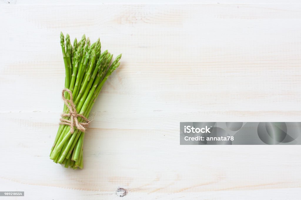 Fresh asparagus on white wood background Fresh asparagus on white wood background. Top view. Copy space Asparagus Stock Photo