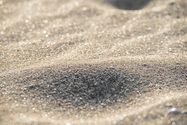 istock Soft Wave Of Blue Ocean On Sandy Beach. Background. Selective focus. 989224080