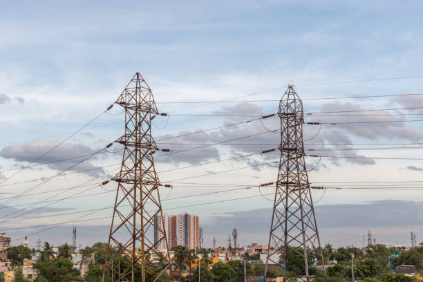 Electricity power substation in chennai india, where electrical power is generated, transmitted, and distributed to systems. Photographed during sunset with low lighting conditions, dark clouds in sky.