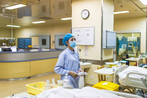 istock Nurse tending patient in intensive care 989250746