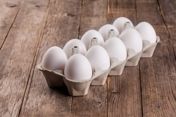 istock white eggs on a wooden background 989250860