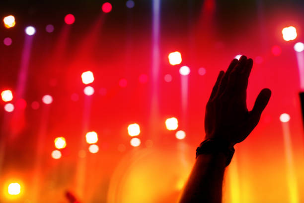 istock cheering crowd in front of bright stage lights 989252456