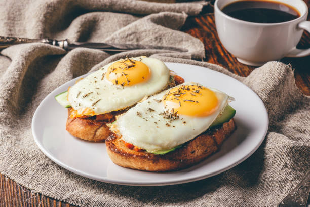 istock Toasts with vegetables and fried eggs with cup of coffee 989257558