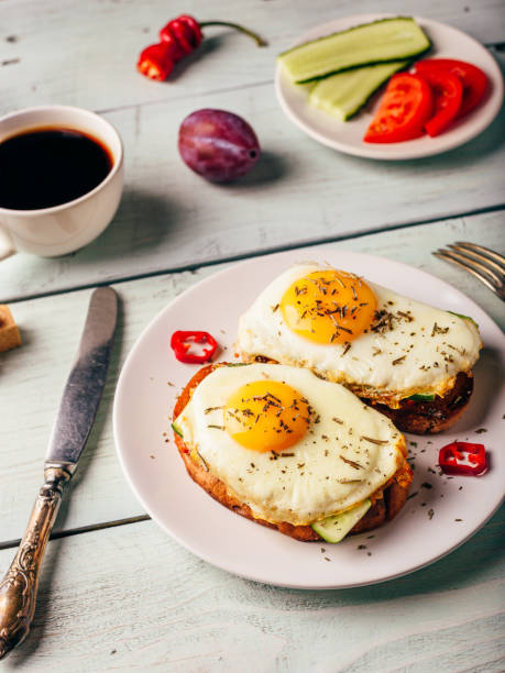 istock Toasts with vegetables and fried egg and cup of coffee 989257596