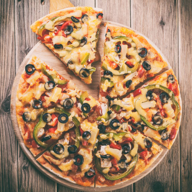 istock Delicious italian pizza served on wooden table 989261154