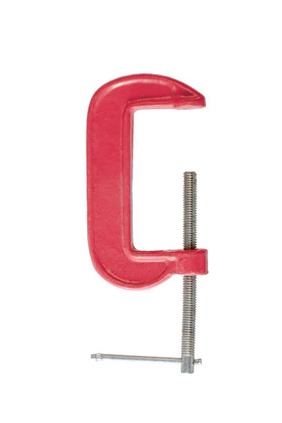 istock red metal vise isolated on white background. old screw clamp tool for holding 989271744