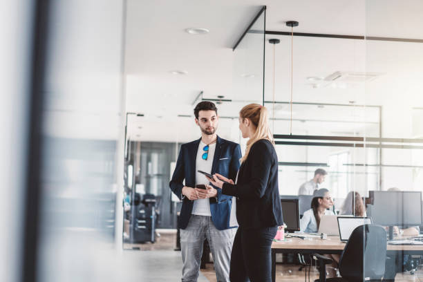 istock Coworkers talking on the hallway 989274284
