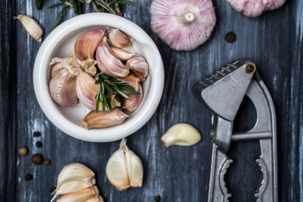 istock Fresh garlic on wooden background. Garlic bulbs 989281112
