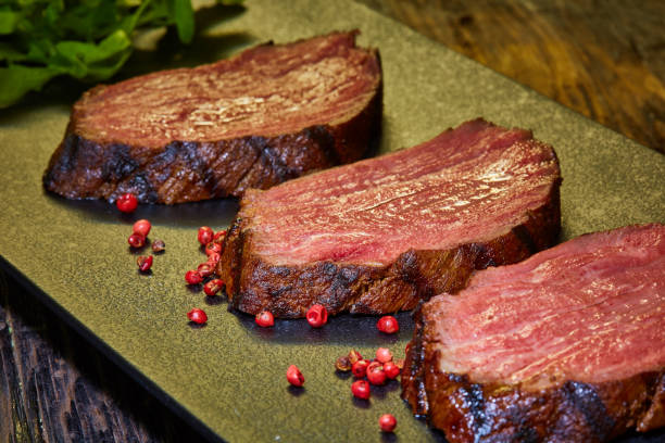 sous-vide steak cut into pieces, cooked to eat beef on the stone table - scotch steak imagens e fotografias de stock