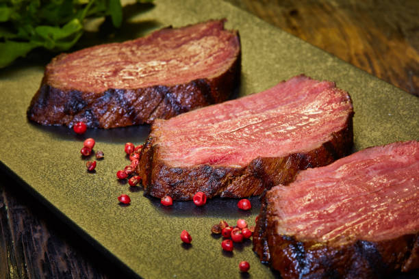 sous-vide steak cut into pieces, cooked to eat beef on the stone table - scotch steak imagens e fotografias de stock