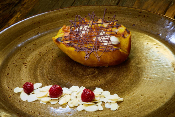 istock Grilled pear dessert decorated with chocolate and almonds 989291592