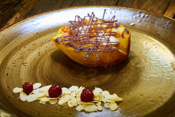 istock Grilled pear dessert decorated with chocolate and almonds 989291678