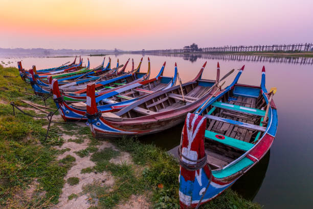 Sunrise at U Bein Bridge with boat, Mandalay, Myanmar. Sunrise at U Bein Bridge with boat, Mandalay, Myanmar. u bein bridge stock pictures, royalty-free photos & images