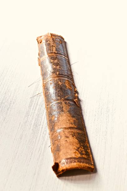 istock Antique damaged books spine on white table 989292866