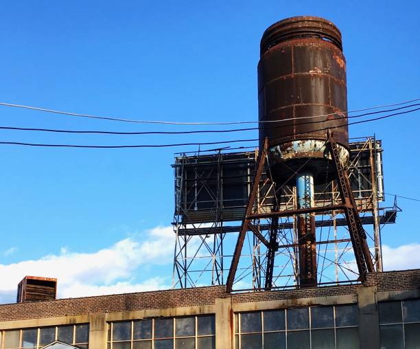istock Old water tower on industrial building 989296942