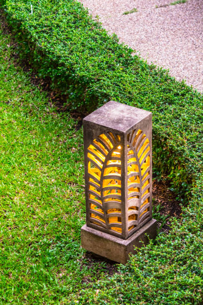 istock Carved stone lamp decoration in garden. 989301440