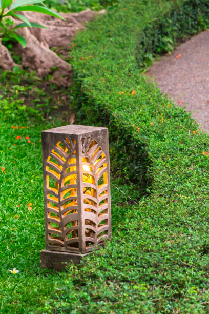 istock Carved stone lamp decoration in garden. 989301570