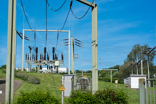 Substation in nature with electricity pylons in sunny weather