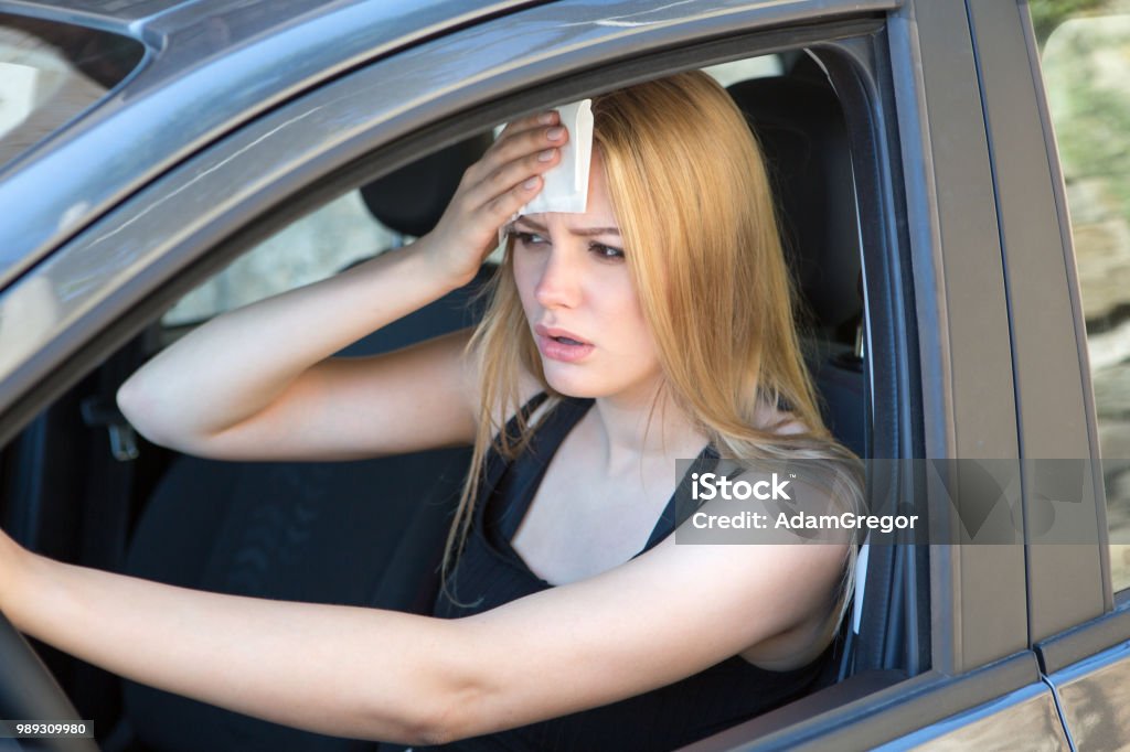 hot during a heat wave Woman being hot during a heat wave in car Car Stock Photo