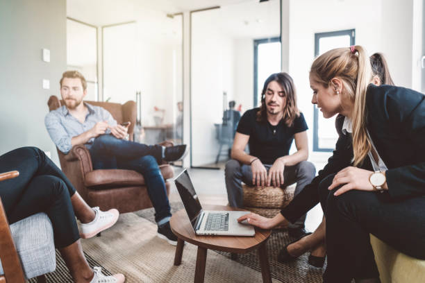 istock Businesswoman in discussion with her team 989326028