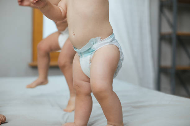 istock Baby in a diaper exploring the bed 989335522