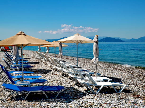 istock Umbrellas straw and sun loungers on the beach 989338476