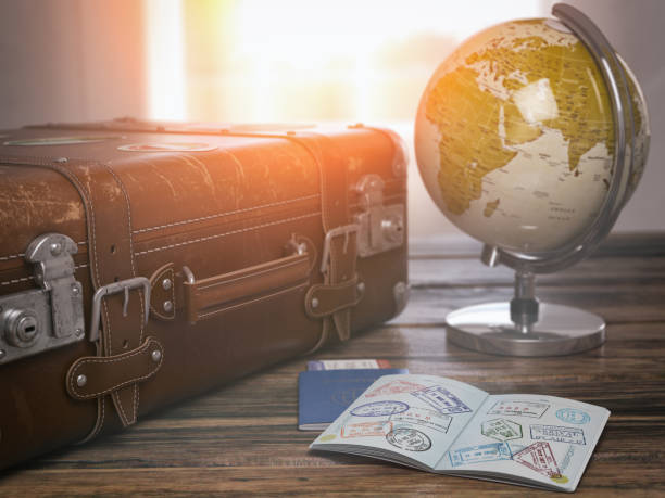 travel or turism concept.  old  suitcase  with open passport with visa stamps and globe. - emigration and immigration passport passport stamp usa imagens e fotografias de stock