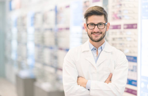 istock Optician wearing glasses at the optical shop 989348978