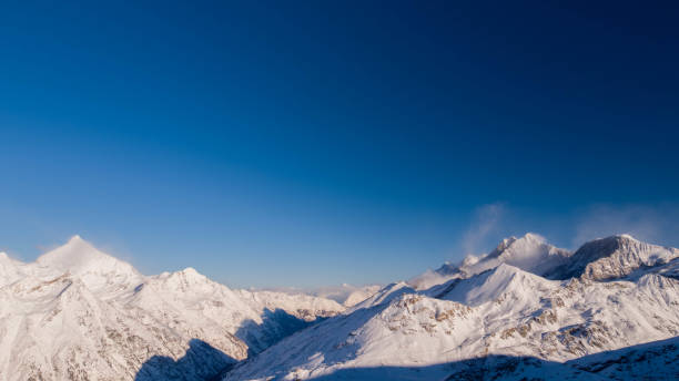 istock snow-capped mountain peaks in winter 989358596