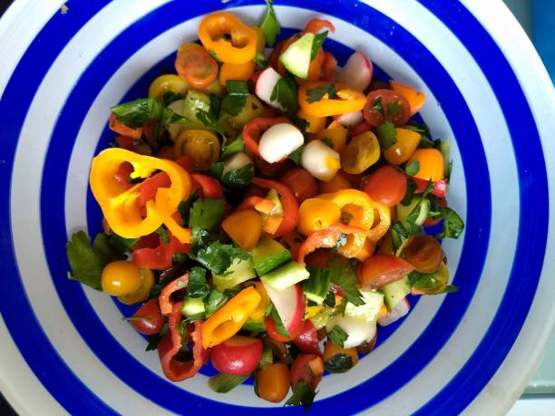 istock Colorful mixed salad in a blue and white bowl 989360292