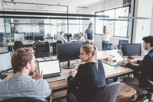 istock Woman discussing plans with colleague in office 989365806