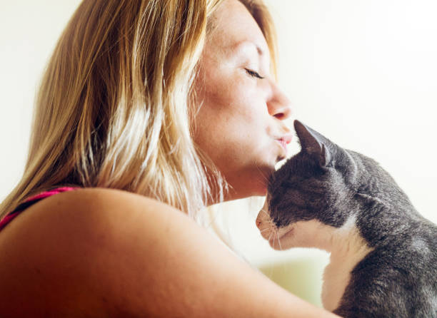 istock Young woman kissing with her cat 989369112