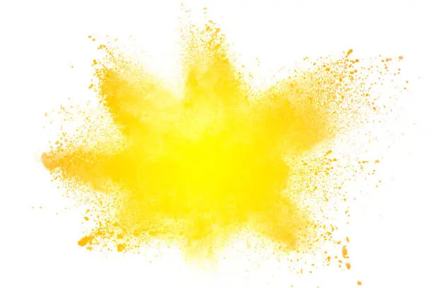 Photo of abstract yellow dust explosion on  white background. abstract yellow powder splatter on white background. Freeze motion of yellow powder splash.