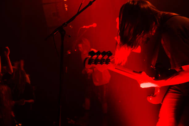 istock Yonung rock band in action on stage 989375186