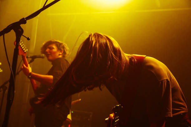 istock Yonung rock band in action on stage 989375504