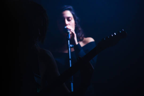 istock Yonung rock band in action on stage 989375640