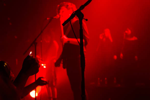 istock Yonung rock band in action on stage 989375850
